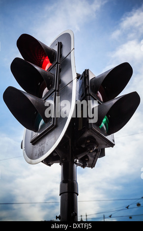 Red stop signal for cars and green pedestrian light on urban traffic light Stock Photo