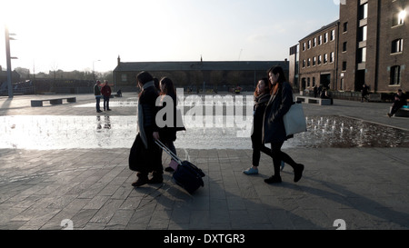 Students outside UAL University of the Arts Central St. Martins campus in Granary Square exterior building in Kings Cross London N1  KATHY DEWITT Stock Photo