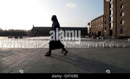 Women walking by fountain outside UAL University of the Arts CSM Central St Martins Art College in Granary Square Kings Cross London UK KATHY DEWITT Stock Photo