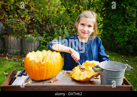 Girl carving Jack O'Lantern Stock Photo