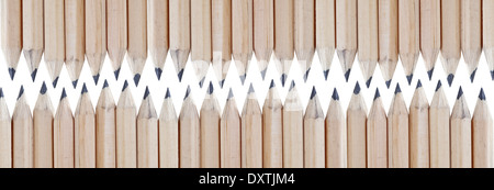 two rows of sharp ground wooden blank graphite pencils facing each other isolated on white Stock Photo