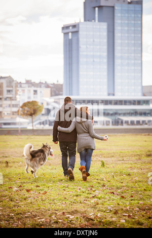 Couple Walking Dog Outdoors, Croatia Stock Photo