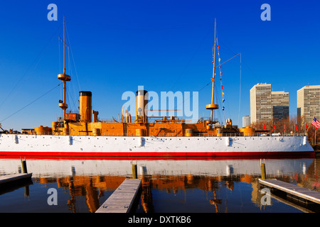 The USS Olympia stands reflective and graceful in the still waters of Penn’s Landing, City of Philadelphia Stock Photo