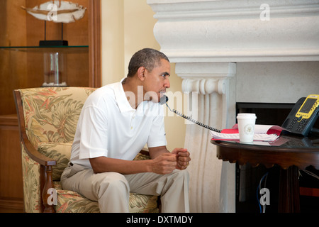 President Barack Obama talks on the telephone with President Francois Hollande of France to discuss the situation in Ukraine, in Key Largo, Florida, March 8, 2014. Stock Photo