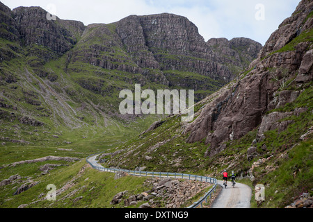 Two cyclists take on Britain's longest road climb in Lochcarron, Scotland Stock Photo