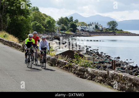 Three cyclists take on Britain's longest road climb in Lochcarron, Scotland Stock Photo