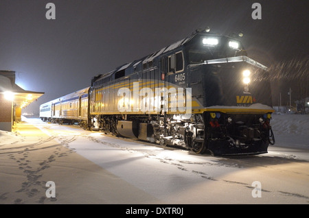 Night photo of Rail Canada Train preparing for departure during light snowfall at Senneterre, Quebec. Stock Photo