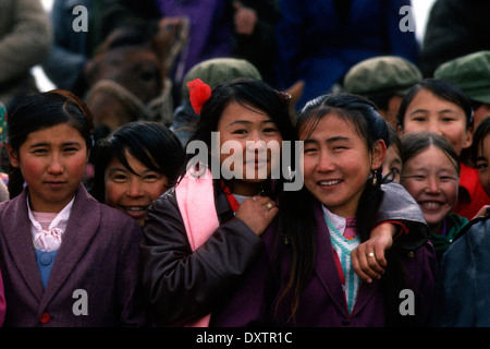 Kazakh boys and girls watching horse racing. These people literally live on horses. Stock Photo