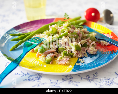 Alphabet pasta with ham and green asparagus Stock Photo