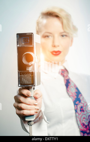 Young Woman Using Video Camera, Portrait Stock Photo