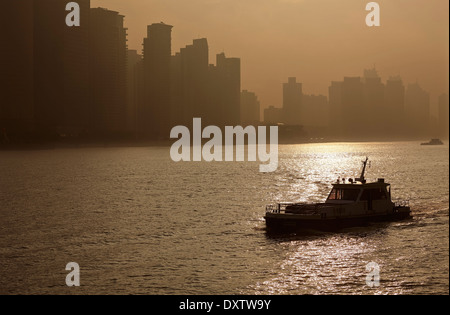 Early morning hazy sunshine on the Huangpu River, with Pudong behind, seen from the Bund, Shanghai, China. Stock Photo