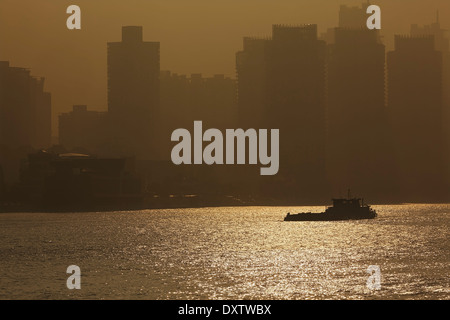 Early morning hazy sunshine on the Huangpu River, with Pudong behind, seen from the Bund, Shanghai, China. Stock Photo