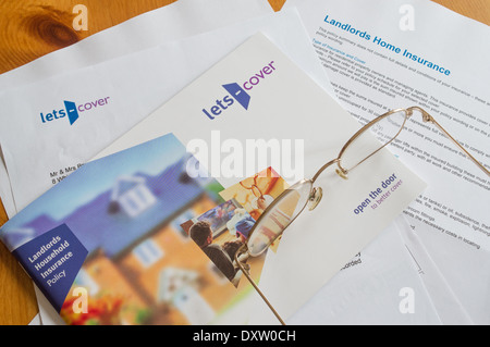 UK Landlord's household insurance documents - Landlords' expenses concept Stock Photo