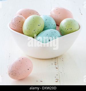 Speckled Easter eggs in a variety of colors. Arranged in a heart shaped bowl. Stock Photo