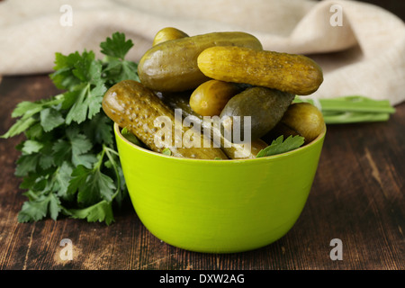 pickled cucumbers in green wooden bowl Stock Photo