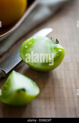 Green tomato cut in half Stock Photo