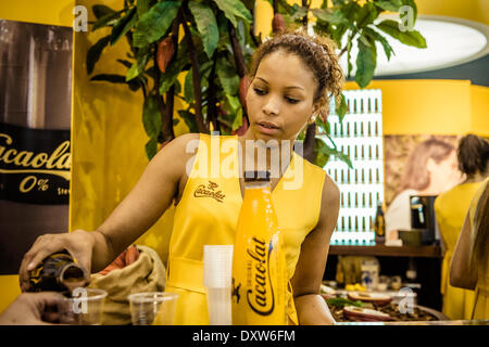 Barcelona, Spain. March 31st, 2014: A hostess at Cacaolat's stand serves the visitors of the 20th edition of the 'Alimentaria' in Barcelona Credit:  matthi/Alamy Live News Stock Photo