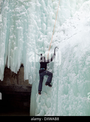 An ice climber scales 'The Queen', a famous ice climb in Maligne Canyon, Jasper National Park, Alberta, Canada. Stock Photo