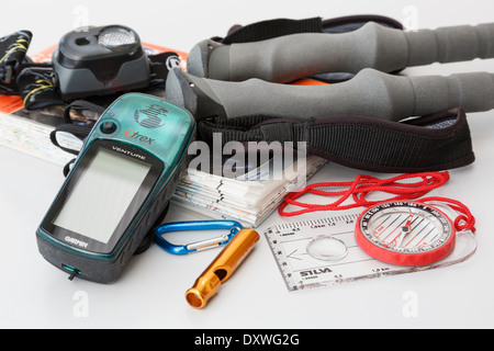 Walking and hiking equipment with Ordnance Survey map, navigation compass, Garmin Etrex GPS, safety whistle, head torch and trekking poles. England UK Stock Photo
