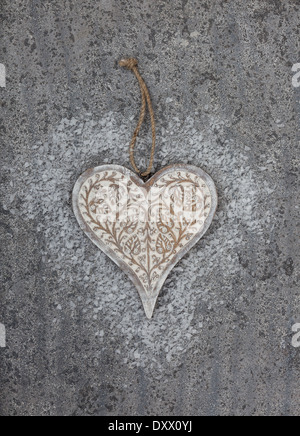 Carved wooden heart on grey limestone background Stock Photo