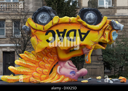 Yellow angel in a car standing on its head, political caricature about the ADAC crisis, papier-mâché figure for the Rose Stock Photo