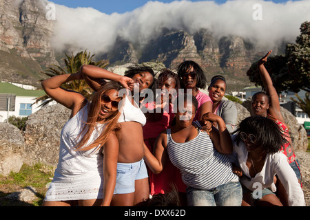 Young women posing in front of the Twelve Apostles, Camps Bay, Cape Town, Western Cape, South Africa Stock Photo
