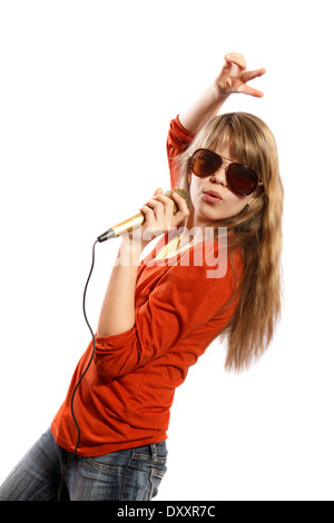 Teenagers girl singing into a microphone on a white background Stock Photo