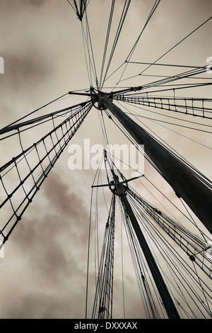 Sailboat masts against stormy sky Stock Photo