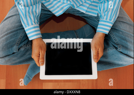 man holding an iPad tablet with blank screen Stock Photo