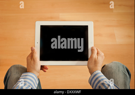 man holding an iPad tablet with blank screen Stock Photo