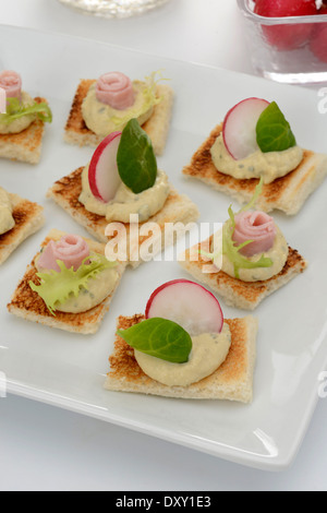 Hummus,radish and ham canapés Stock Photo