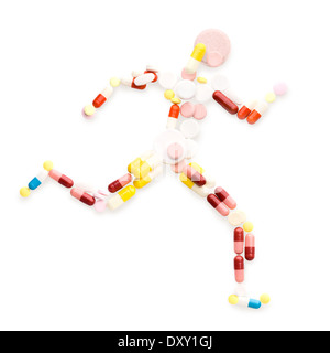 Doping drugs and pills in the shape of an athletic runner on track. Stock Photo