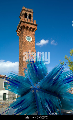 Clock tower and blue glass sculpture by Simone Cenedese in Campo Santo Stefano, Murano, Venice, Italy Stock Photo