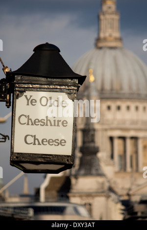 Ye Olde Cheshire Cheese pub sign on Fleet Street with dome of St Paul's Cathedral in background City of London England UK Stock Photo