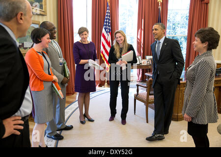 US President Barack Obama receives an update on Affordable Care Act in the Oval Office of the White House April 1, 2014 in Washington, DC. With the President, from left, are: Phil Schiliro, Assistant to the President and Special Advisor; Tara McGuinness, Senior Communications Advisor; Marlon Marshall, Principal Deputy Director of Public Engagement; Jeanne Lambrew, Deputy Assistant to the President for Health Policy; Kristie Canegallo, Advisor to Chief of Staff; and Senior Advisor Valerie Jarrett. Stock Photo