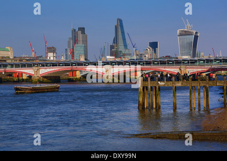 Wooden pier at Oxo Tower Wharf on the River Thames with Blackfriars Bridge and the City of London skyline in London, England Stock Photo