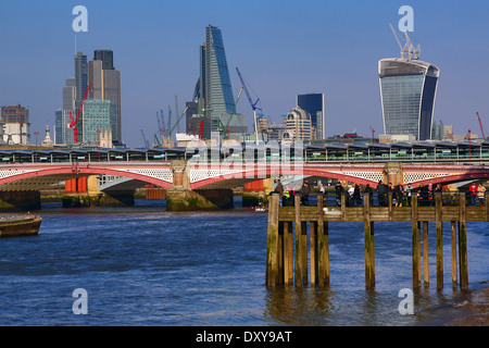 Wooden pier at Oxo Tower Wharf on the River Thames with Blackfriars Bridge and the City of London skyline in London, England Stock Photo