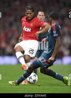 Manchester, UK. 1st April, 2014. Old Trafford, Manchester, England, UEFA Champions League quarter-final. Manchester United versus Bayern Munich. Antonio Valencia (Manchester United FC) gets his shot away past David Alaba (Bayern) Credit:  Action Plus Sports Images/Alamy Live News Stock Photo