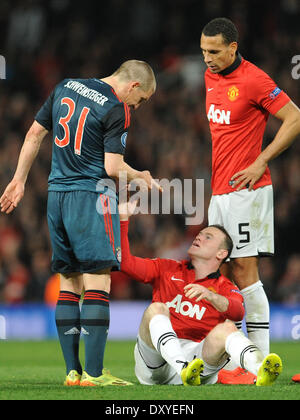 Manchester, Britain. 01st Apr, 2014. Munich's Bastian Schweinsteiger (L) talks to Manchester United's Wayne Rooney (C) and Rio Ferdinand after being sent off during the UEFA Champions League quarter final first leg soccer match between Manchester United and FC Bayern Munich at Old Trafford stadium in Manchester, Britain, 01 April 2014. Photo: Andreas Gebert/dpa/Alamy Live News Stock Photo