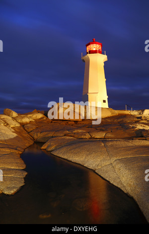 A light-painting and reflection of Peggy's Cove lighthouse on a stormy winter night, Nova Scotia, Canada. Stock Photo