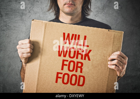 Man needs a job. Unemployed man holding board with title WILL WORK FOR FOOD Stock Photo