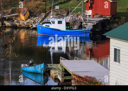Fishing boat and others at rest in a peaceful inlet - Herring Cove, Halifax, Nova Scotia, Canada. Stock Photo