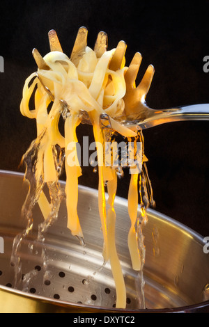 Tagliatelle is a traditional type of pasta from Emilia-Romagna and Marche, regions of Italy. Stock Photo