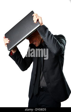 Business man hides under the laptop in his hands Stock Photo