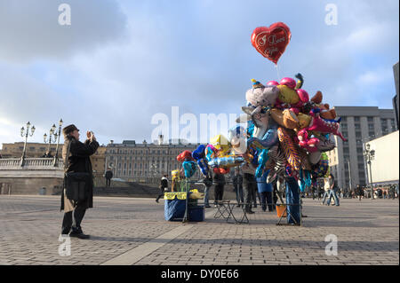 A visitor photographs a balloon seller in Manezhnaya Square. Stock Photo