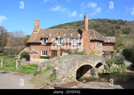 Picturesque old pack horse bridge over the Aller Brook at Allerford in Exmoor National Park North Somerset Stock Photo