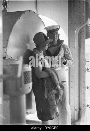 Sailor of HMAS 'Australia' fondles woman's string of pearls, c. 1929 / by Sam Hood Stock Photo