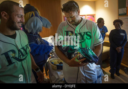 April 1, 2014 - St. Petersburg, Florida, U.S. - Tampa Bay Ray HEATH BELL (center) holds newborn Khai Watson as teammate SEAN RODRIGUEZ (left) looks on at the Bayfront Baby Place. The Rays were there to give special ''Rays Fan for Life'' gifts. Babies born on opening day were given a certificate good for four tickets to all future Rays home openers. (Credit Image: © John Pendygraft/Tampa Bay Times/ZUMAPRESS.com) Stock Photo