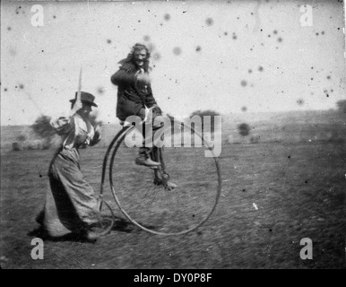 Man on a penny-farthing bicycle being chased by his sister (Maggie & Bob Spiers) - West Wyalong, NSW, C. 1900 Stock Photo
