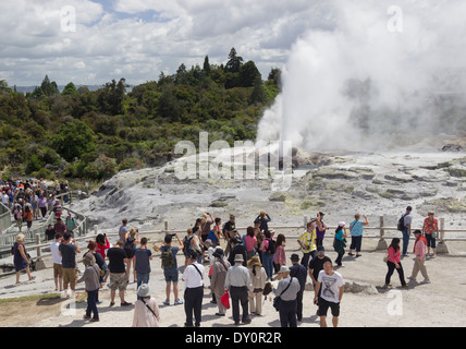 Crowds of spectators watching Grand Geyser erupting